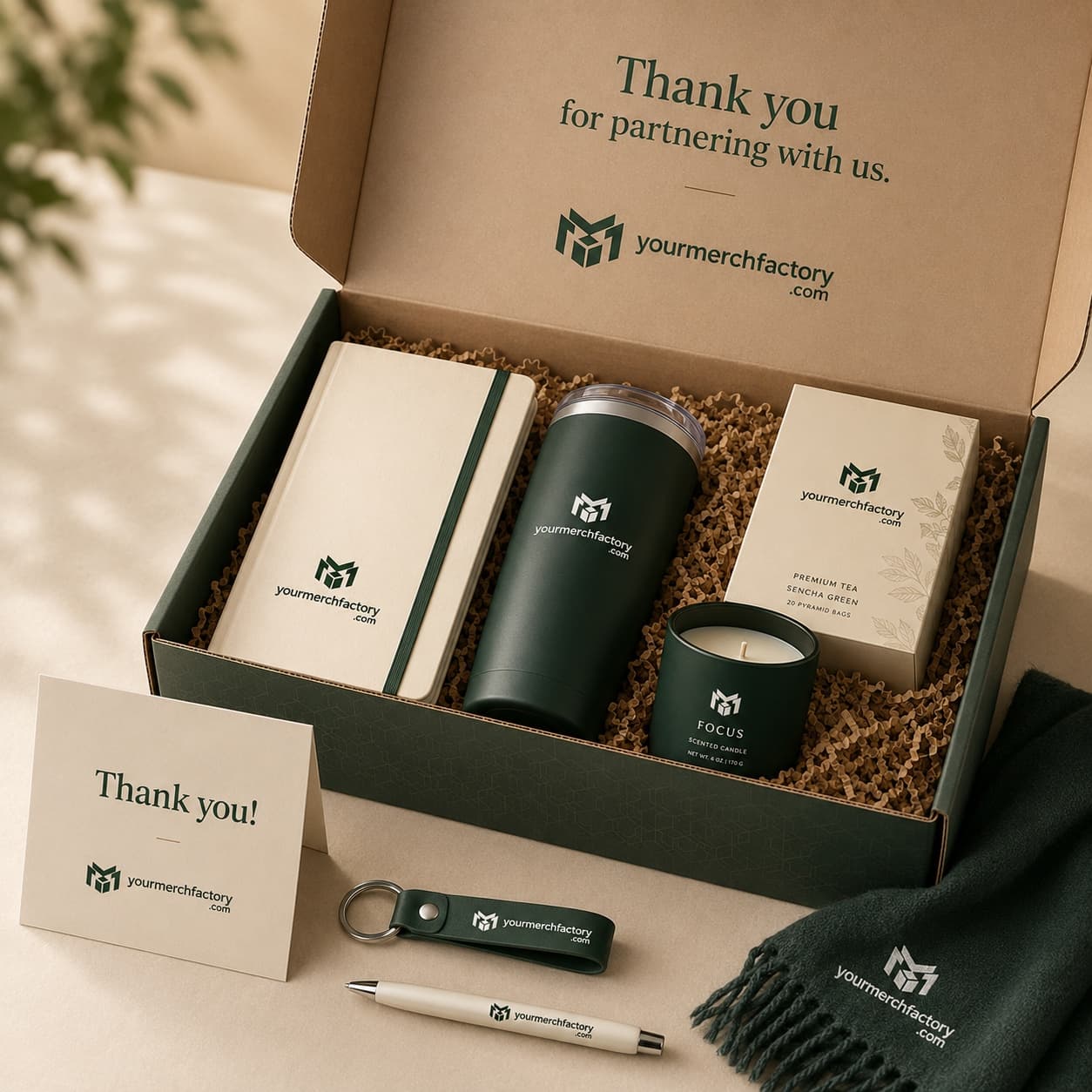 A premium client gift box with curated branded items on a warm neutral surface