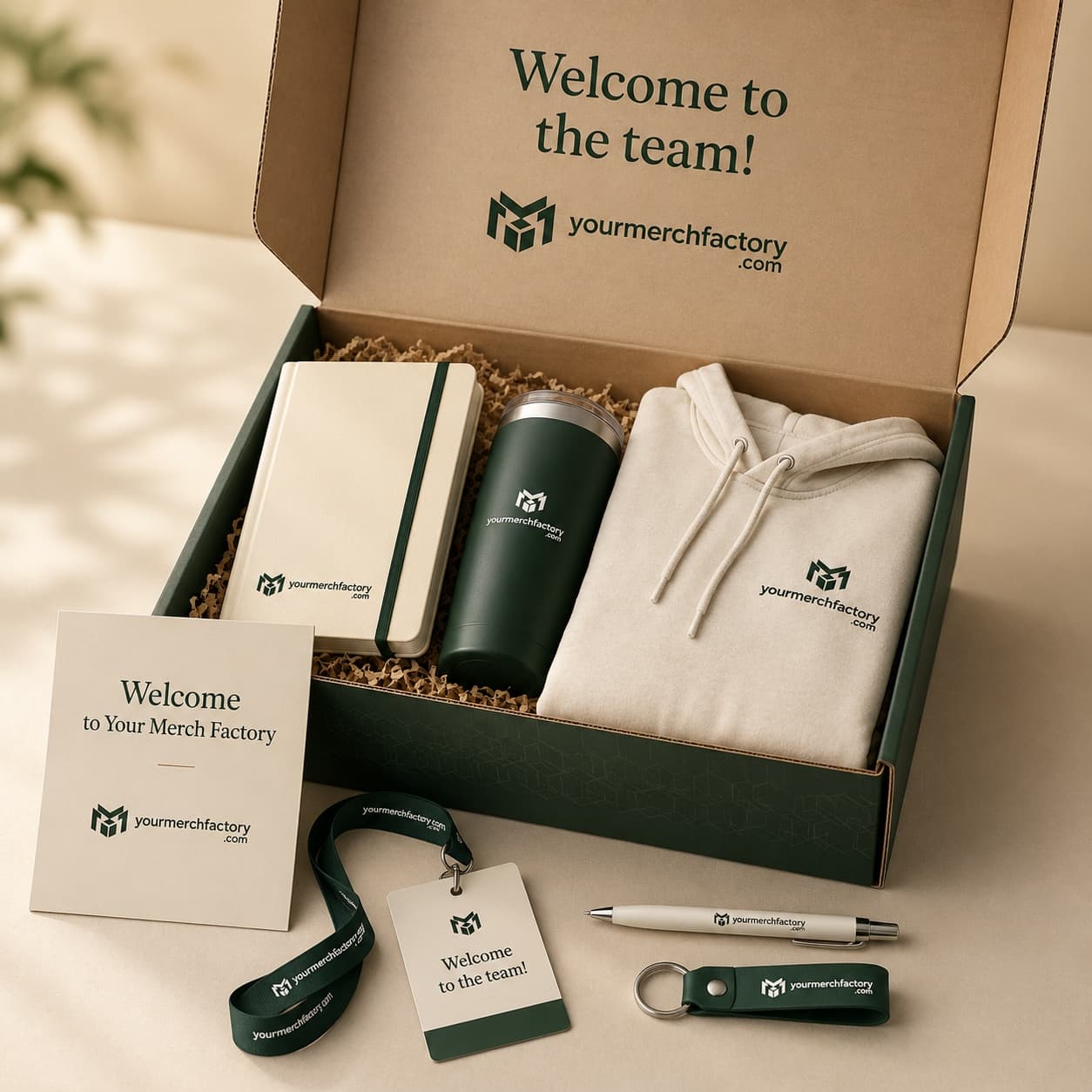 A branded new-hire welcome kit with apparel, a tumbler, and a notebook in a gift box