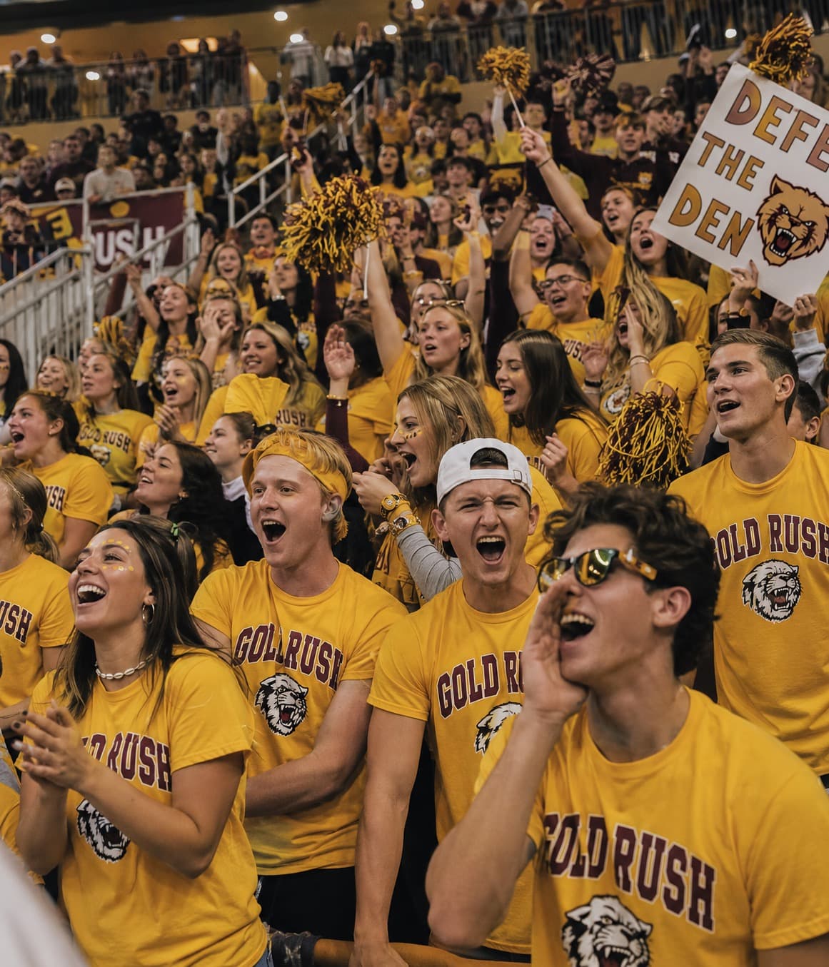 A packed student section in matching custom spirit-wear shirts on game day