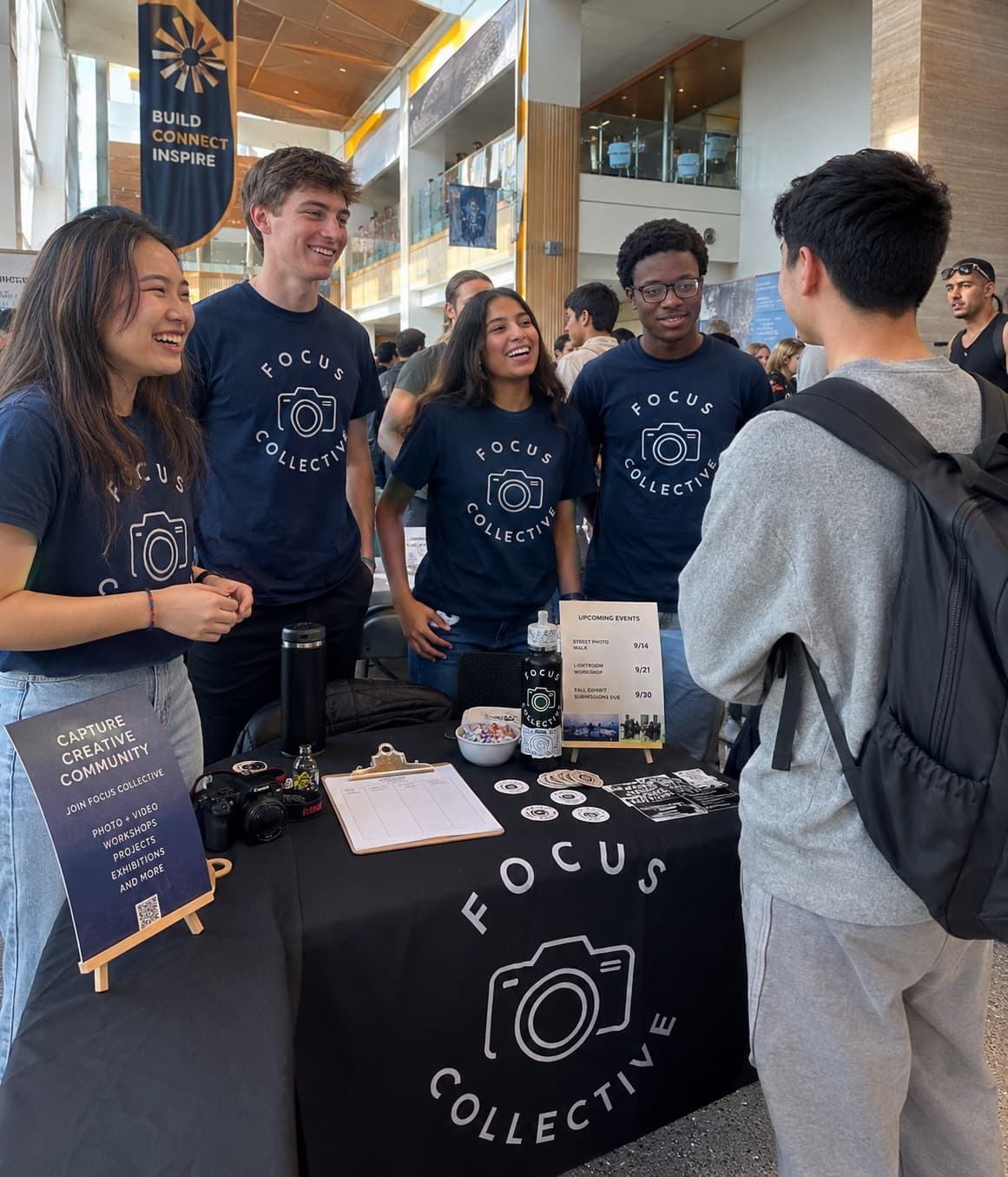 A student organization tabling at the involvement fair in matching custom shirts